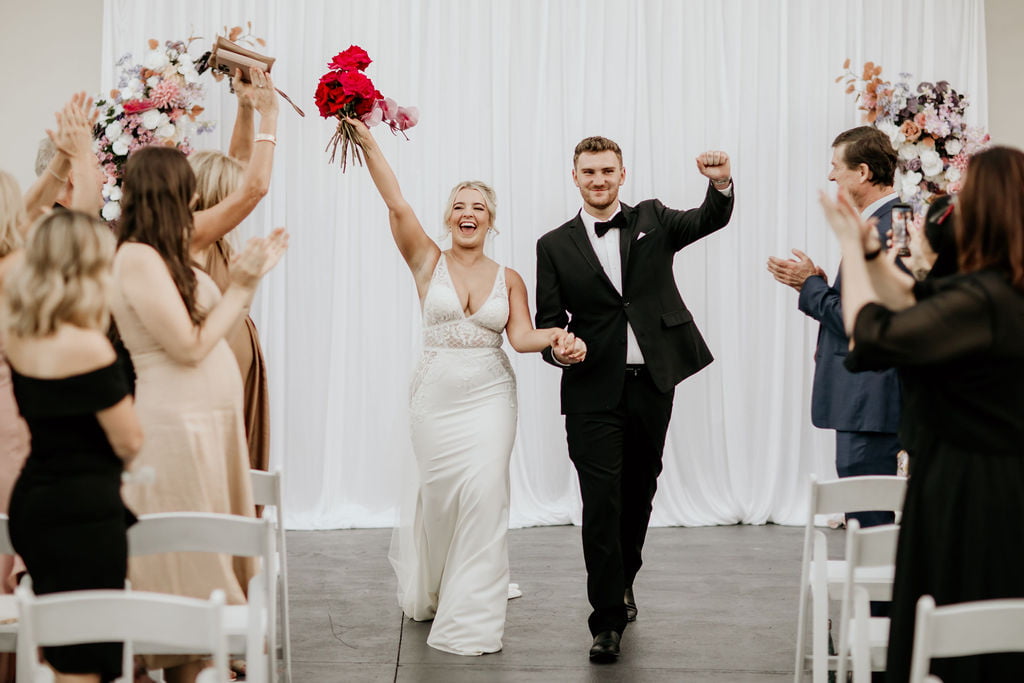 a man and woman walking down a aisle